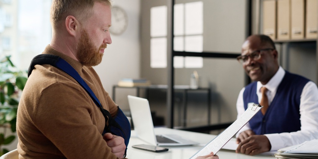 Attorney helping an injured man receive the maximum settlement after an accident.