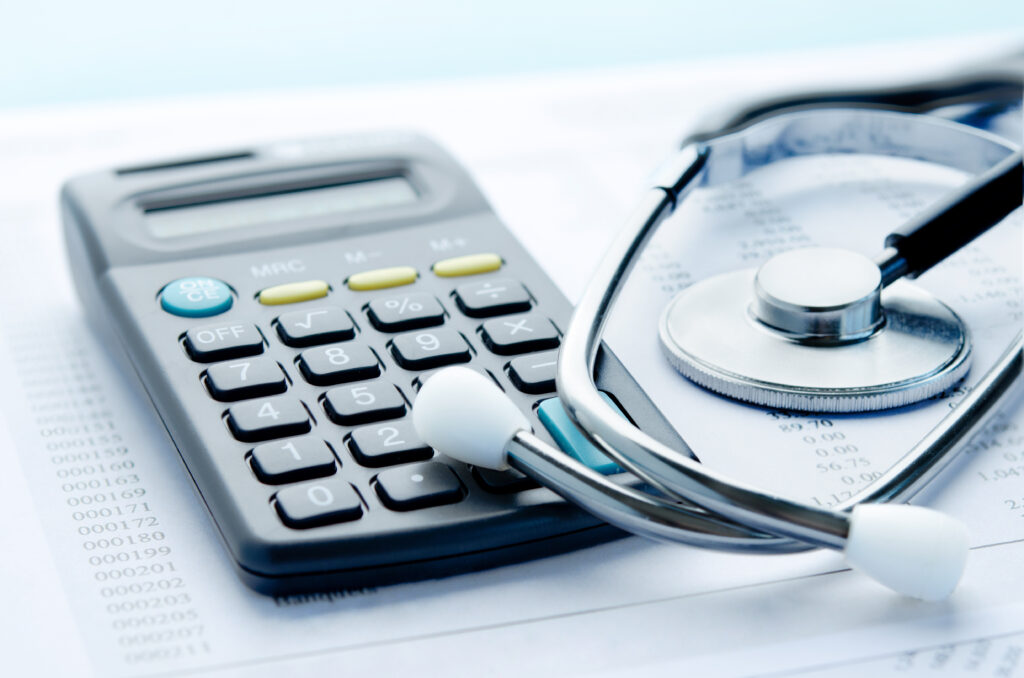 calculator near medical bills and stethoscope to indicate what can be compensated with a personal injury claim